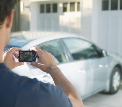 Man photographing new car